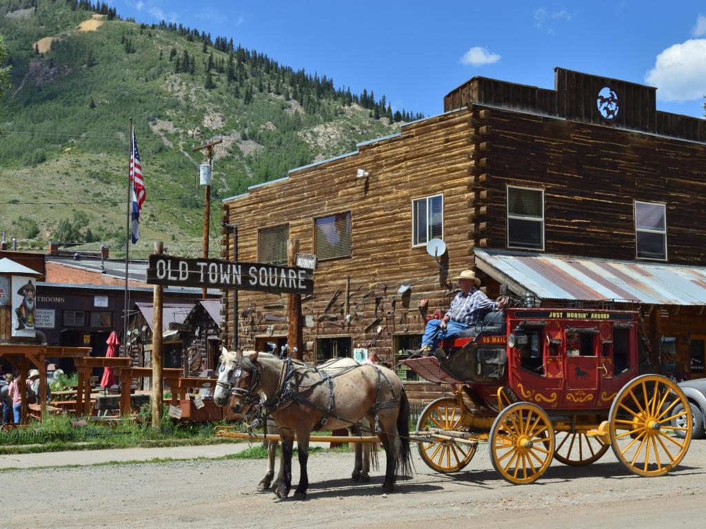Horse and carriage in the Old Town Square in Silverton, Colorado, with the mountains in the background