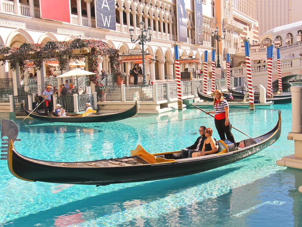 Tourists enjoying a real experience of Gondola ride in at the Grand Canal in Venetian Hotel Las Vegas