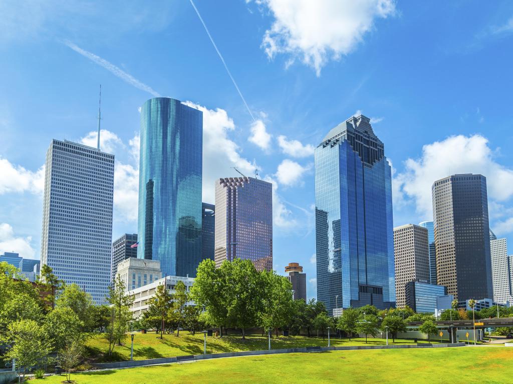 Houston, Texas, USA with a skyline of Houston in daytime under a blue sky.