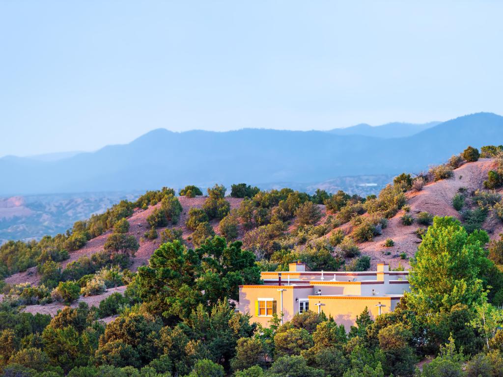 High desert mountain house home during summer sunset and twilight blue hour in Santa Fe, New Mexico