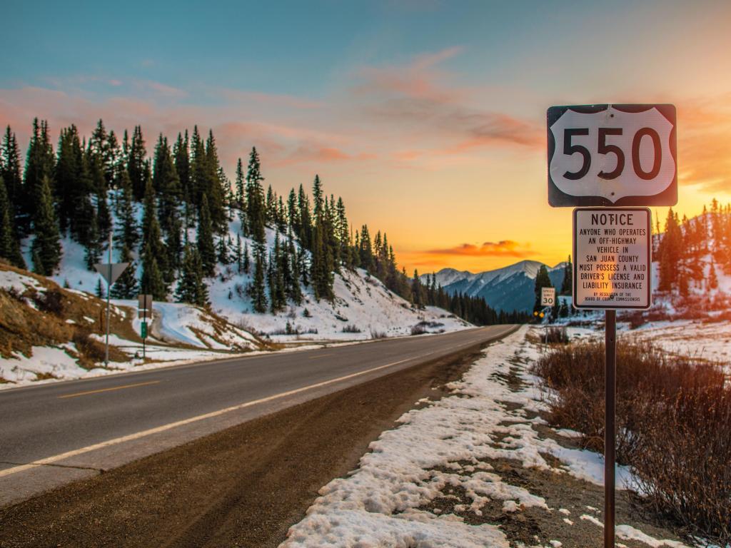 Million Dollar Highway near Durango, Colorado, with highway sign at sunset 