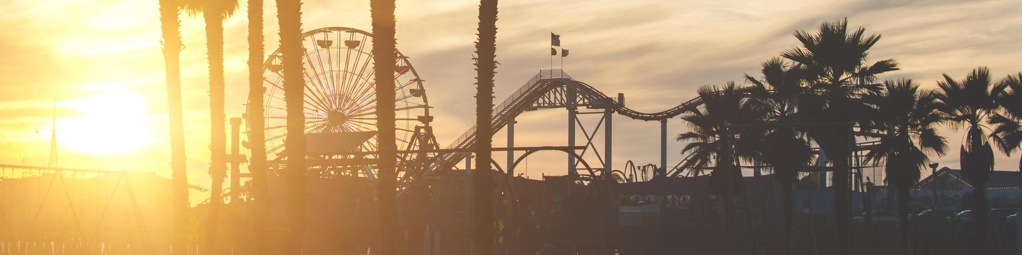 Santa Monica, California, USA with a view of the pier with palms silhouettes at sunset.