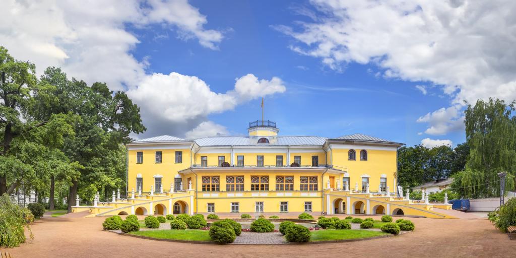 The yellow exterior of the baroque style Governor's House (now Yaroslavl Art Museum) with a garden and fountain in front