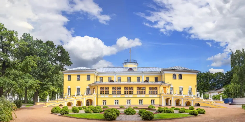The yellow exterior of the baroque style Governor's House (now Yaroslavl Art Museum) with a garden and fountain in front