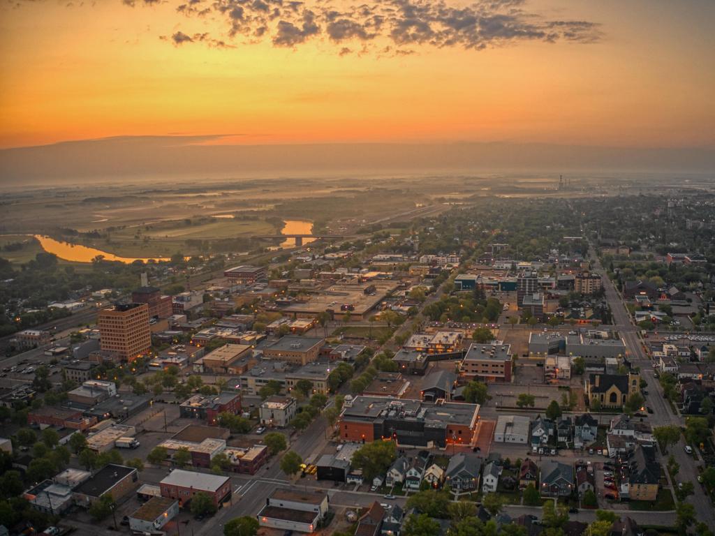 Aerial view of Brandon's downtown during a bold, orange sunset