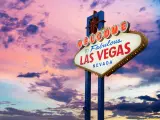 Famous "Welcome To Las Vegas" neon sign with a purple and pink sunset in the background
