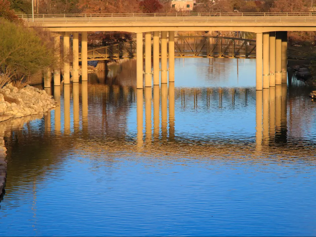 Sandy coloured bridge over calm river in late afternoon light