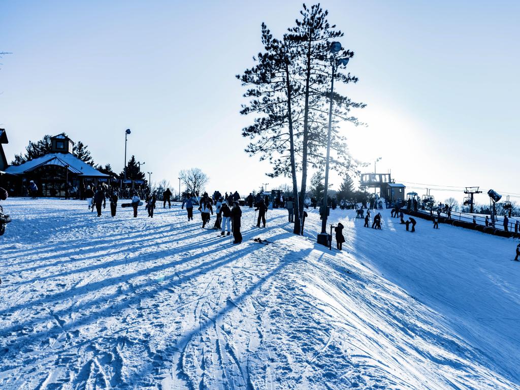 Skiers, snowboarders and walkers on the snow at the resort