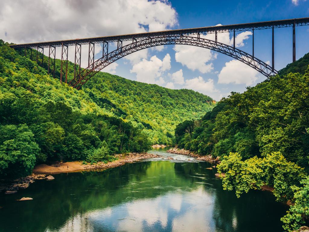 New River Gorge National River, West Virginia, USA taken at the New River Gorge Bridge, seen from Fayette Station Road with the river reflecting the trees and taken on a sunny day.