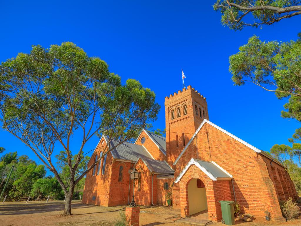 The Anglican Church of the Holy Trinity In Western Australia surrounded by blue skies and trees