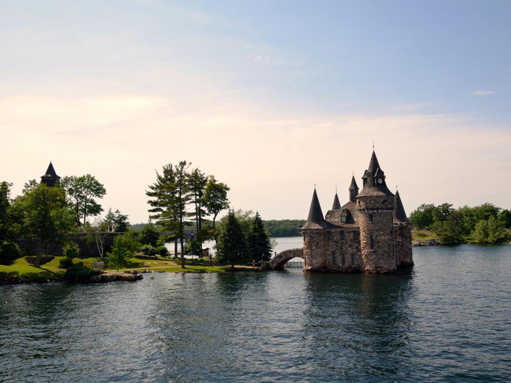 St. Lawrence River, Ontario, Canada part of the Thousand Islands cruise with a castle building surrounded by water just before sunset.