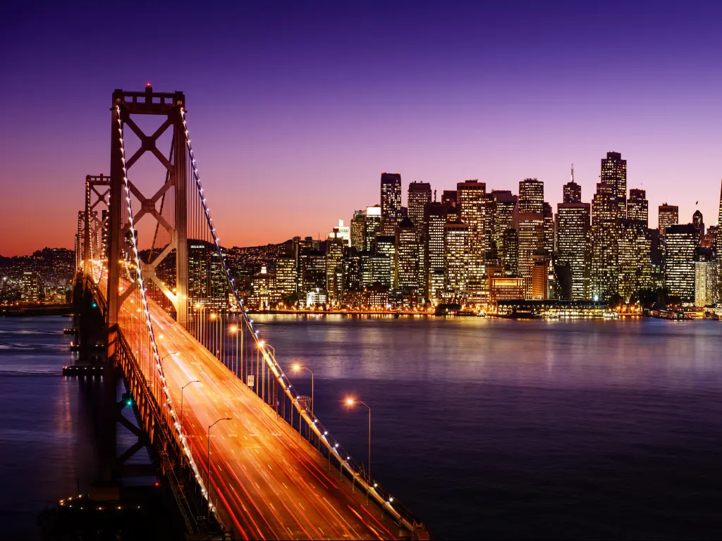 San Francisco skyline and Bay Bridge at sunset, California