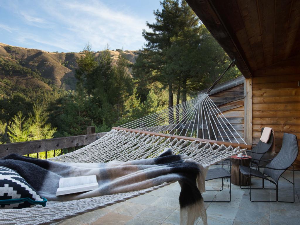 Views over the Big Sur mountains from a balcony with a hammock in Ventana Big Sur.