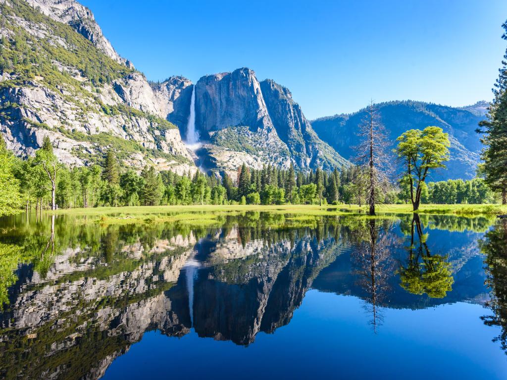 Yosemite National Park, California, USA with reflections in Merced River of Yosemite waterfalls and beautiful mountain landscape.