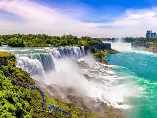Niagara Falls, USA taken as a panorama view of the falls from the American side on a sunny day.