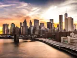 New York City Skyline at sunset with Brooklyn Bridge and Wall Street skyscrapers 