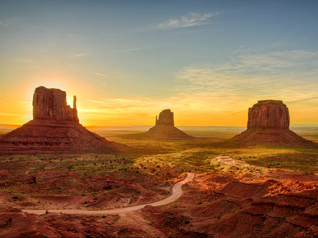 The iconic buttes of Monument Valley at sunrise on the Utah - Arizona border.