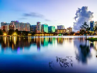 Orlando, USA with the downtown city at twilight, the still water in the foreground reflecting the skyscrapers. 