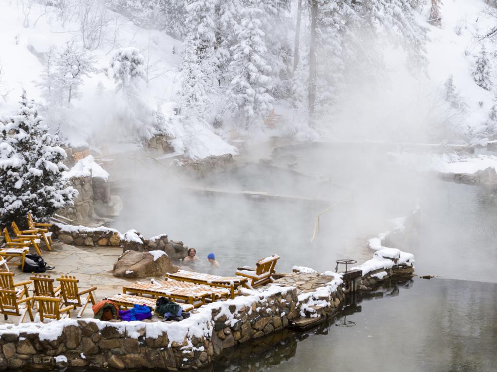 The hot water of Strawberry Park Hot Springs during a snowy winter, near Steamboat Springs, Colorado