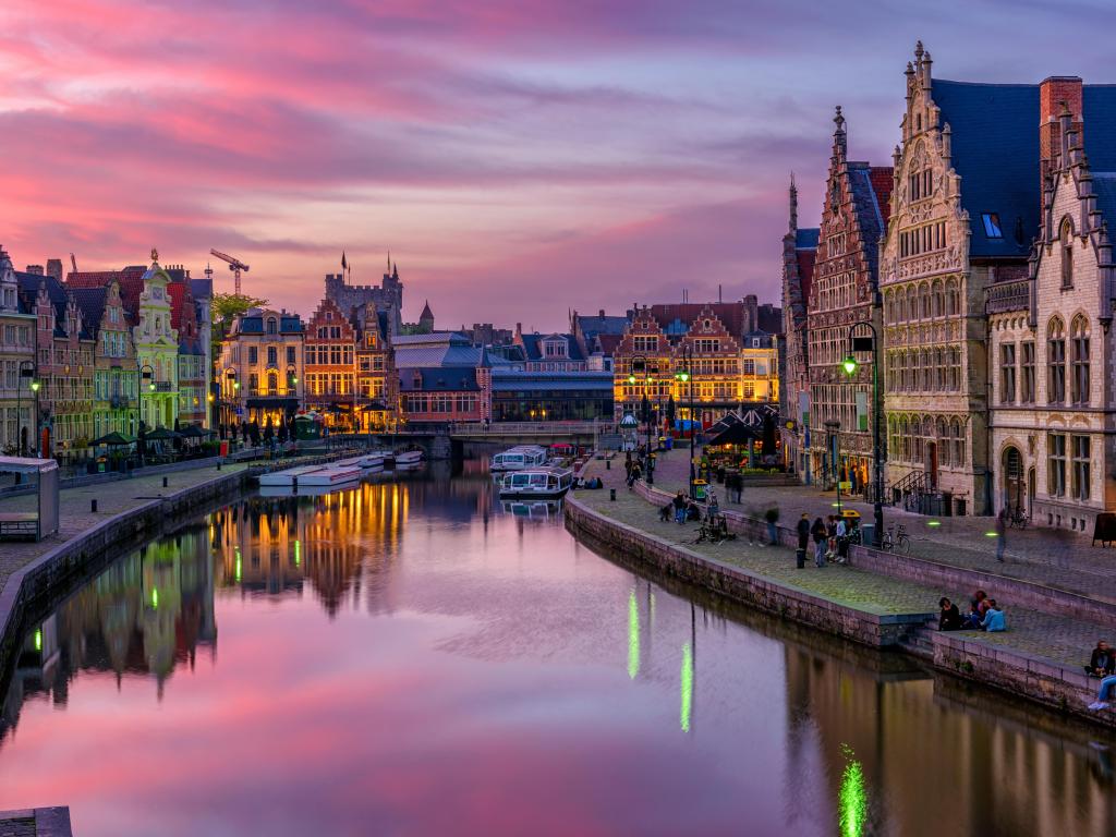 View of Graslei, Korenlei quays and Leie river in the historic city center in Ghent (Gent), Belgium. Architecture and landmark of Ghent. Sunset cityscape of Ghent.