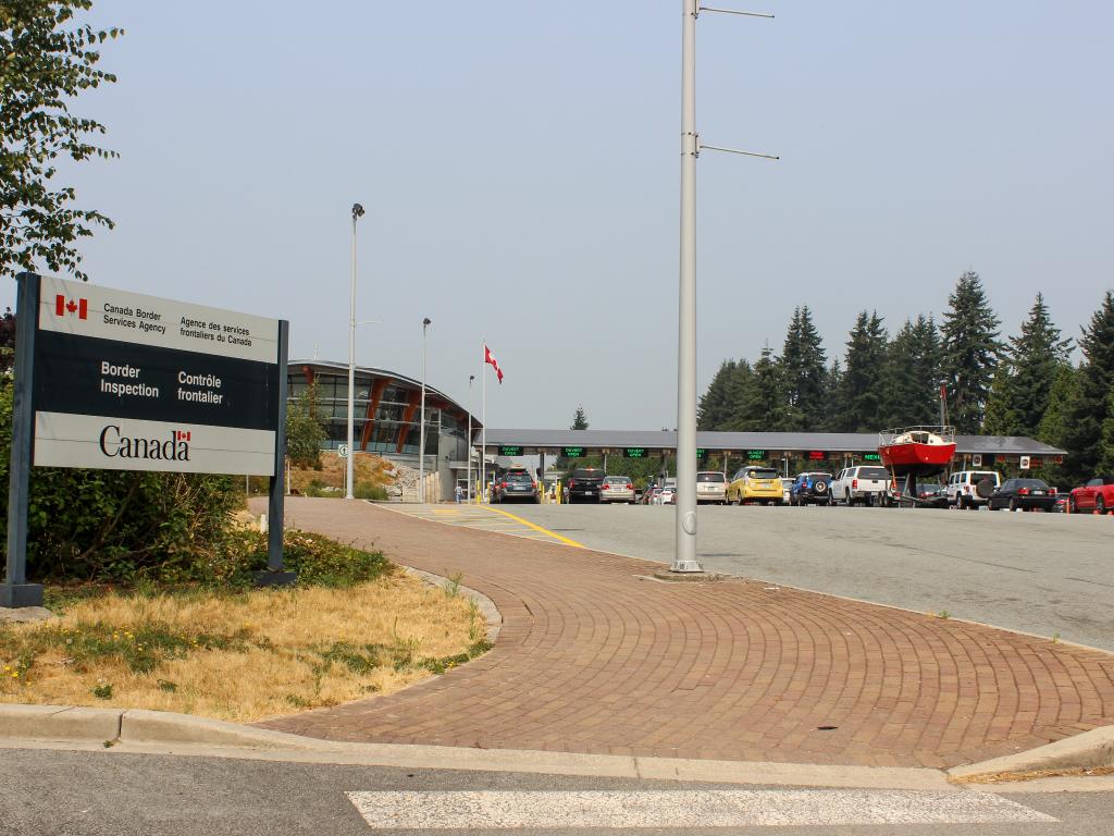 Cars in a queue at a border crossing from the United States into Canada on the way to Alaska