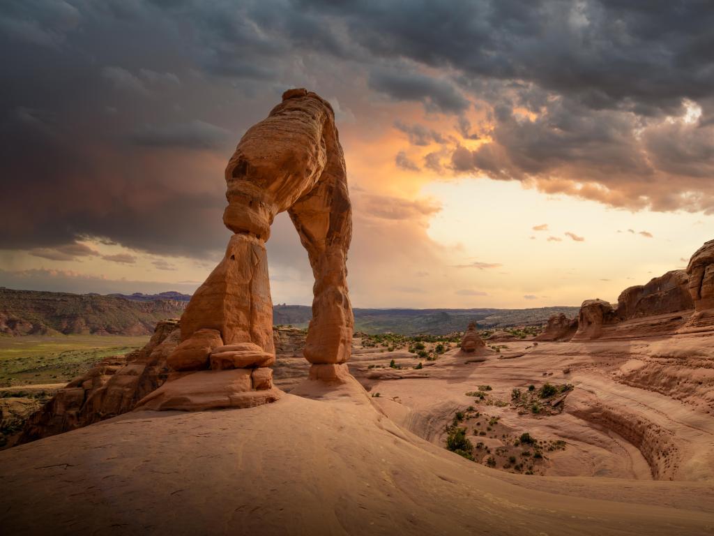 Arches National Park, Utah, USA during sunset with stormy skies approaching the Delicate Arch hike with iconic USA landscape.