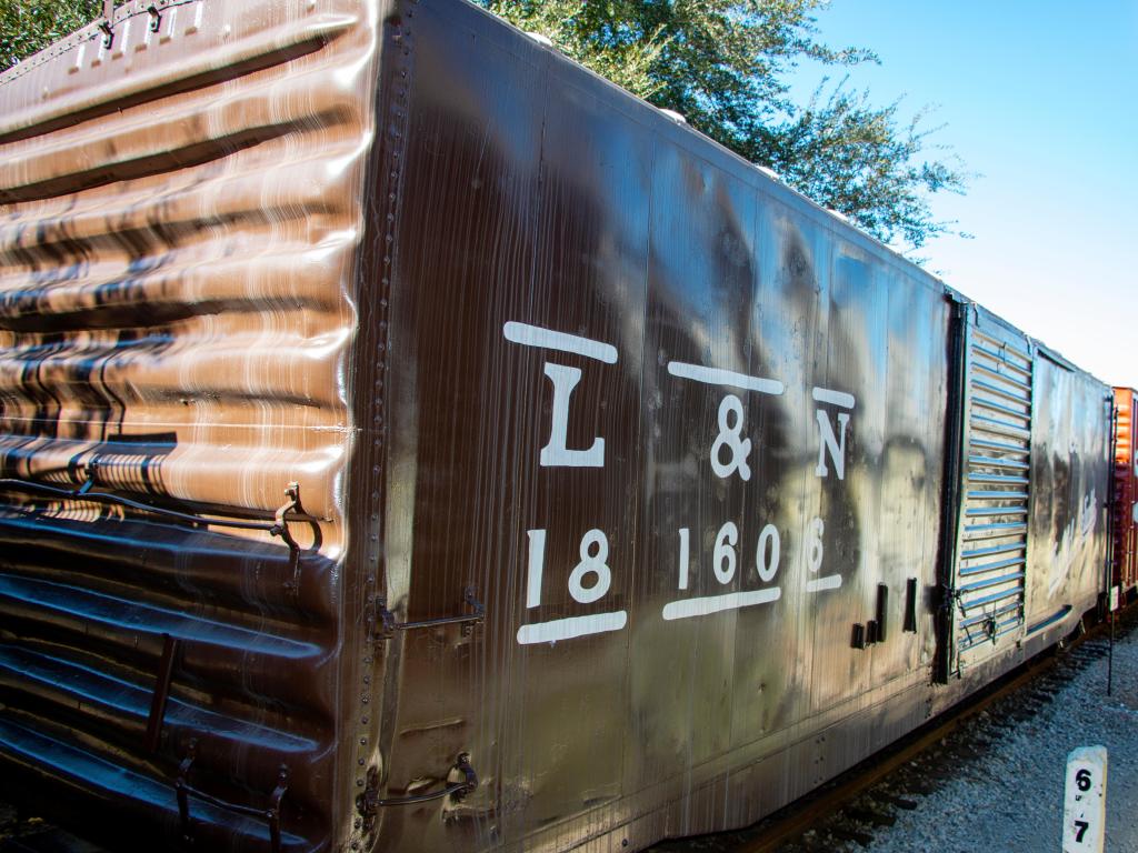 Close-up shot of some brown and dark red colored retired vintage train cars standing at Foley Railroad Museum, Alabama 