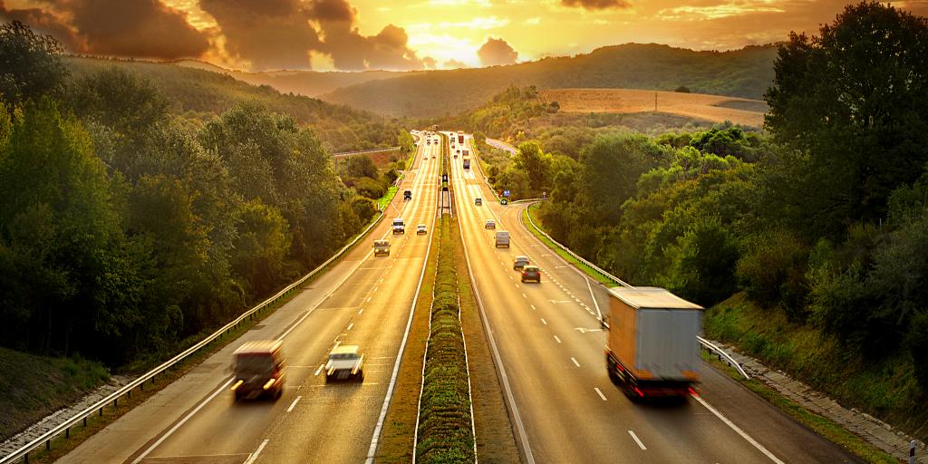 cars driving along the motorway at sunset 