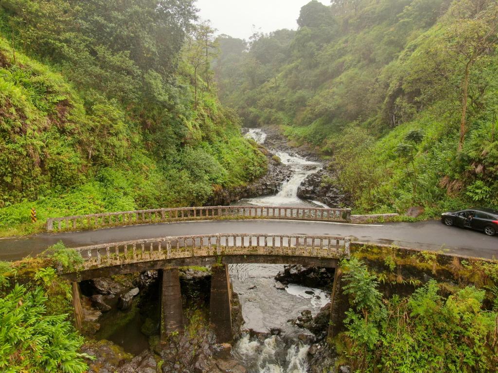 Bridge of Road to Hana over streams running underneath and surrounded by lush steep forests, Hawaii
