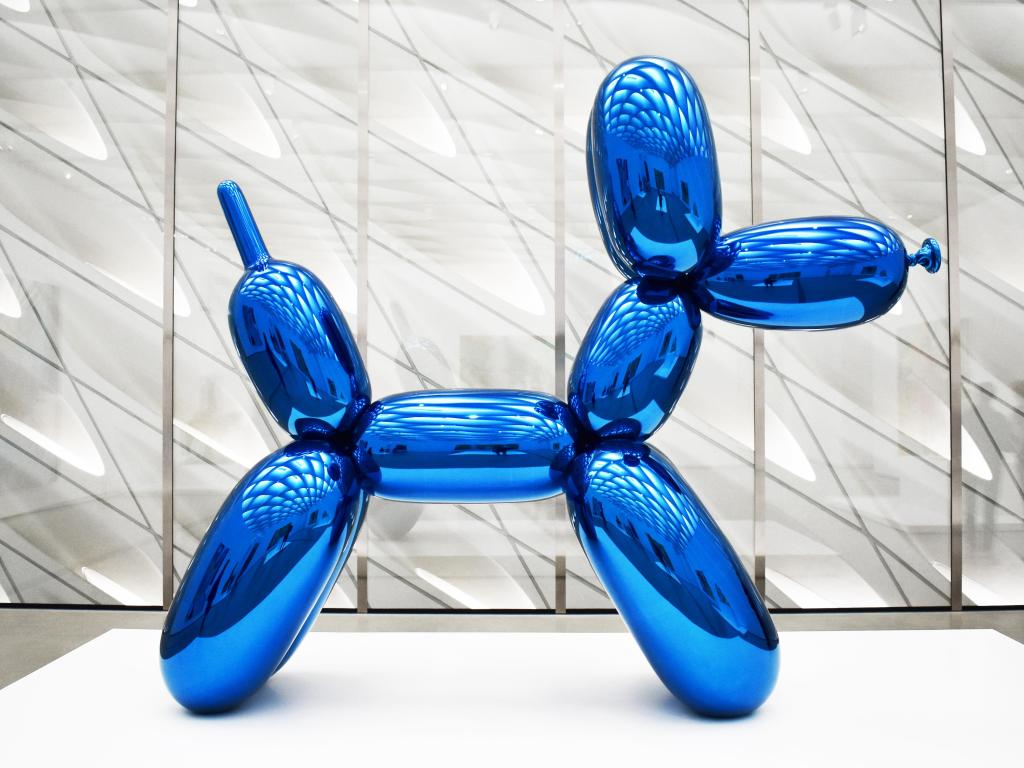 Blue balloon dog sculpture by Jeff Koons exhibited in museum