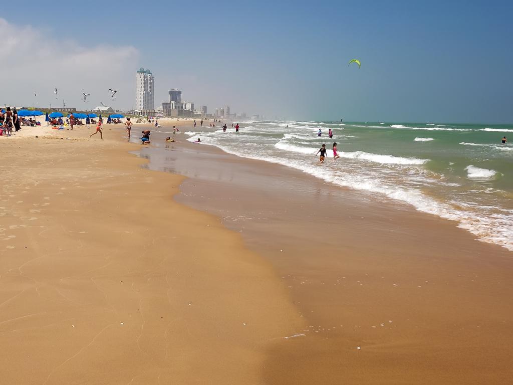 Long sandy beach with hotels in the background on South Padre Island, Texas.