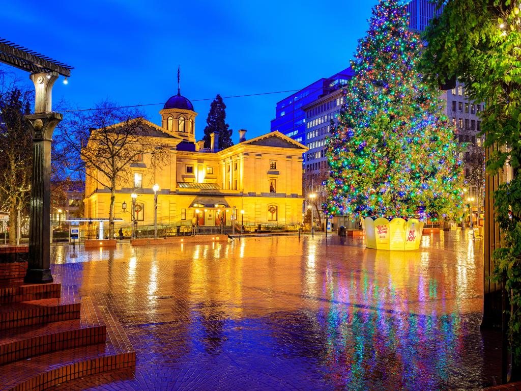 Night time shot of Pioneer Courthouse with a festive tree in the town square at Christmas in Portland Oregon