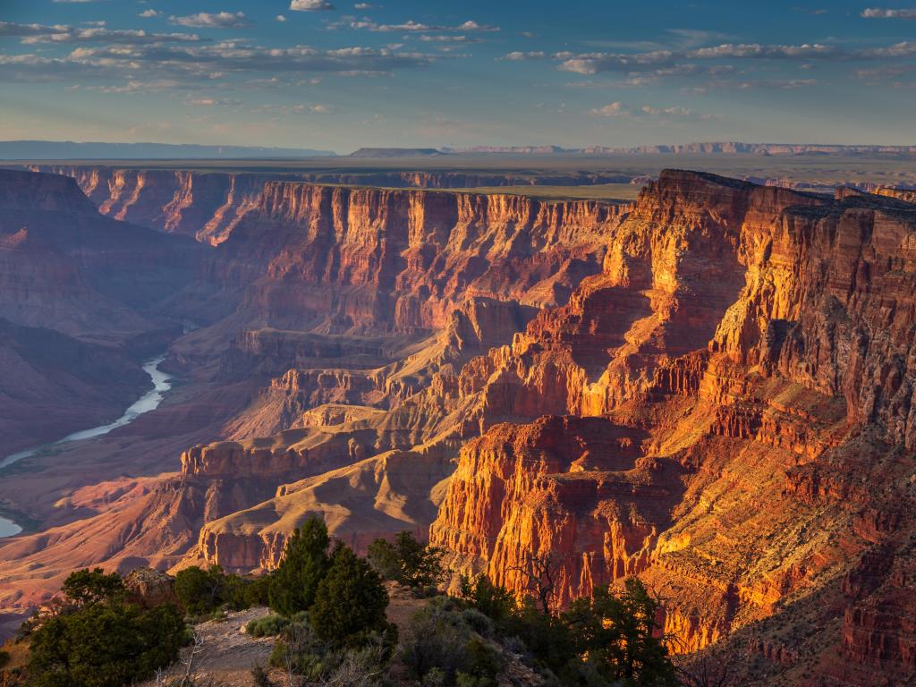 Grand Canyon National Park, Arizona, USA with a view of the Colorado Plateau at Sunset and a river running through the great canyons.