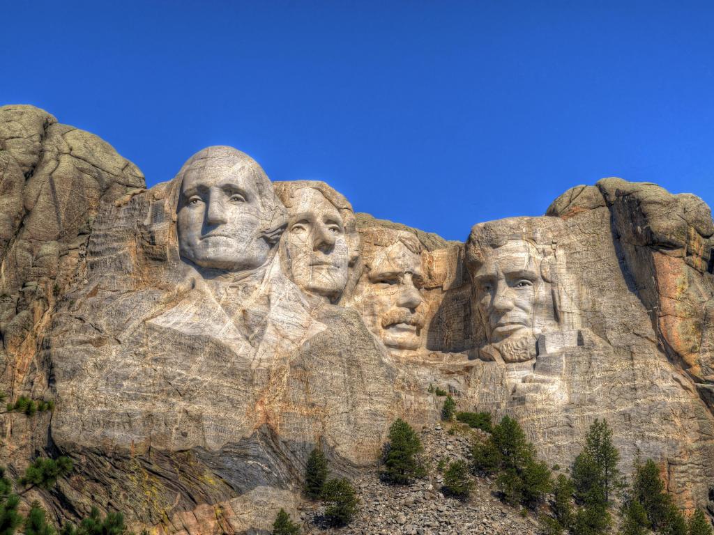 Mt. Rushmore National Memorial in South Dakota, USA with a blue sky.