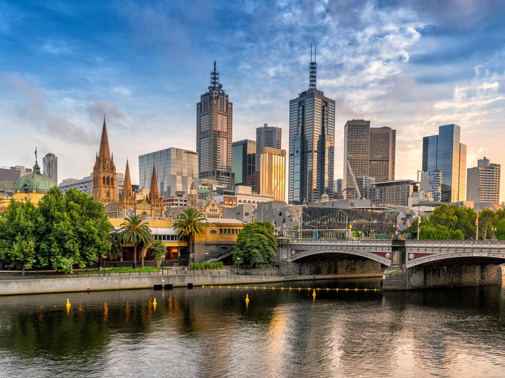 Melbourne, Australia with the city in the background at sunset overlooking the water in the foreground.