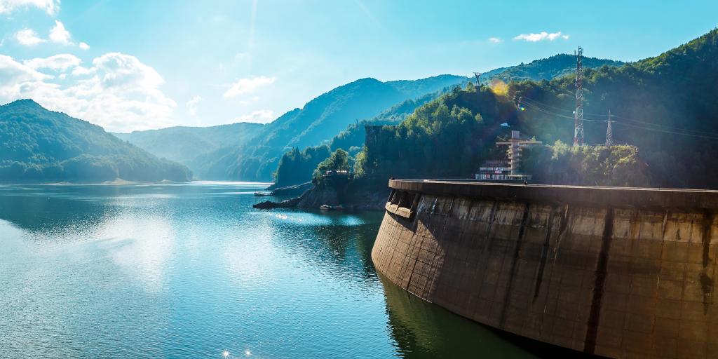 Views from the Vidraru Dam across Vidraru Lake on a sunny day in Romania 