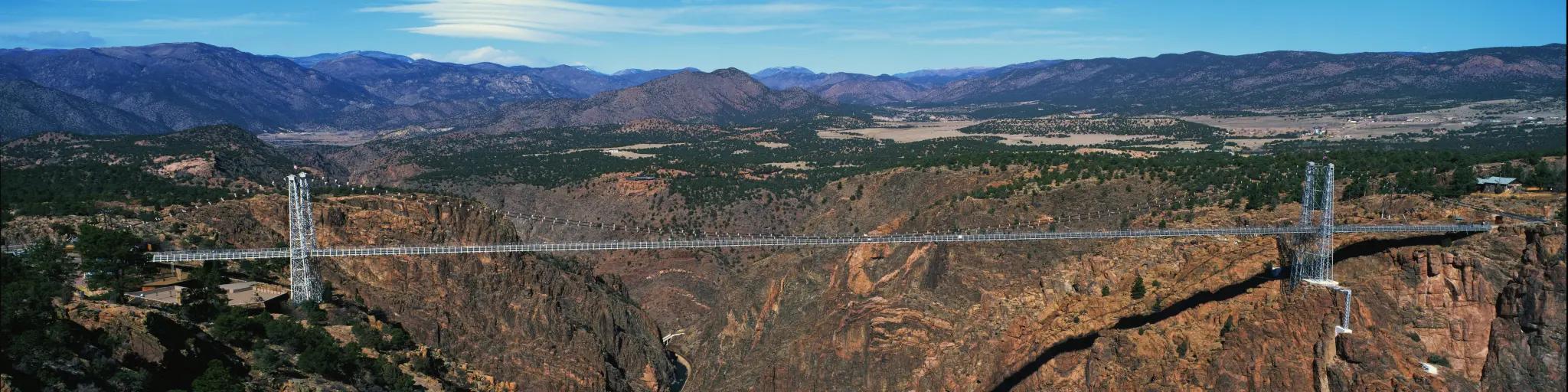 Panoramic view of the Royal Gorge Bridge, the largest suspension bridge in the USA, on a sunny day with blue sky above