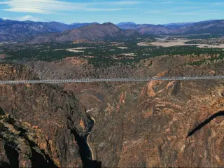 Panoramic view of the Royal Gorge Bridge, the largest suspension bridge in the USA, on a sunny day with blue sky above