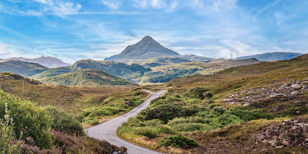 View of Ben Stack mountain peak and the smaller surrounding mountains, with a road cutting through the middle 