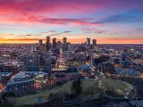 Downtown Denver, Colorado, USA. Drone skyline aerial panorama. The photo is taken at sunset and depicts a colorful sky behind the city skyline.