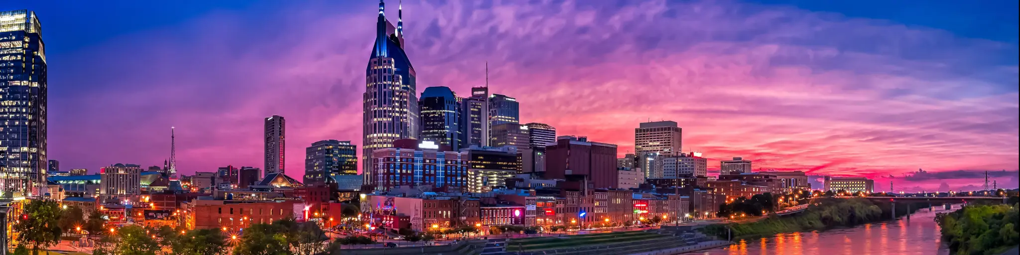 Nashville Skyline at sunset with buildings set against a purple sky