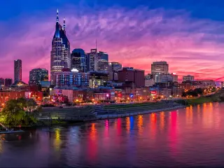 Nashville Skyline at sunset with buildings set against a purple sky