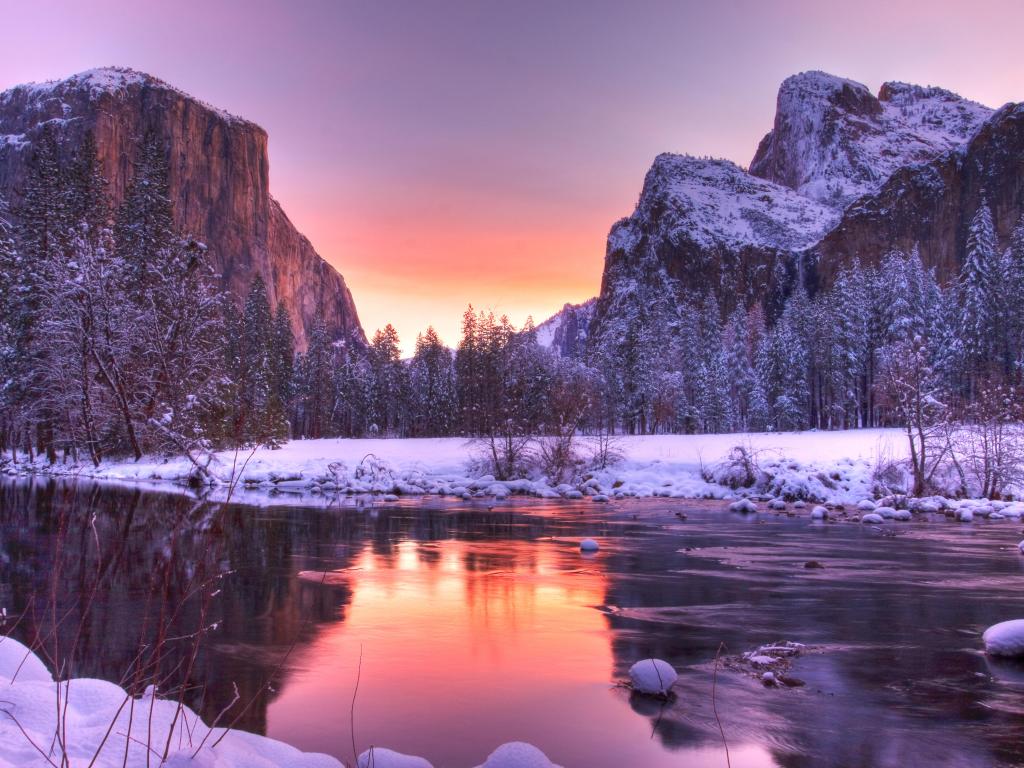 Yosemite Valley Sunrise at winter, with a purple and pink-hued sky reflecting on a lake