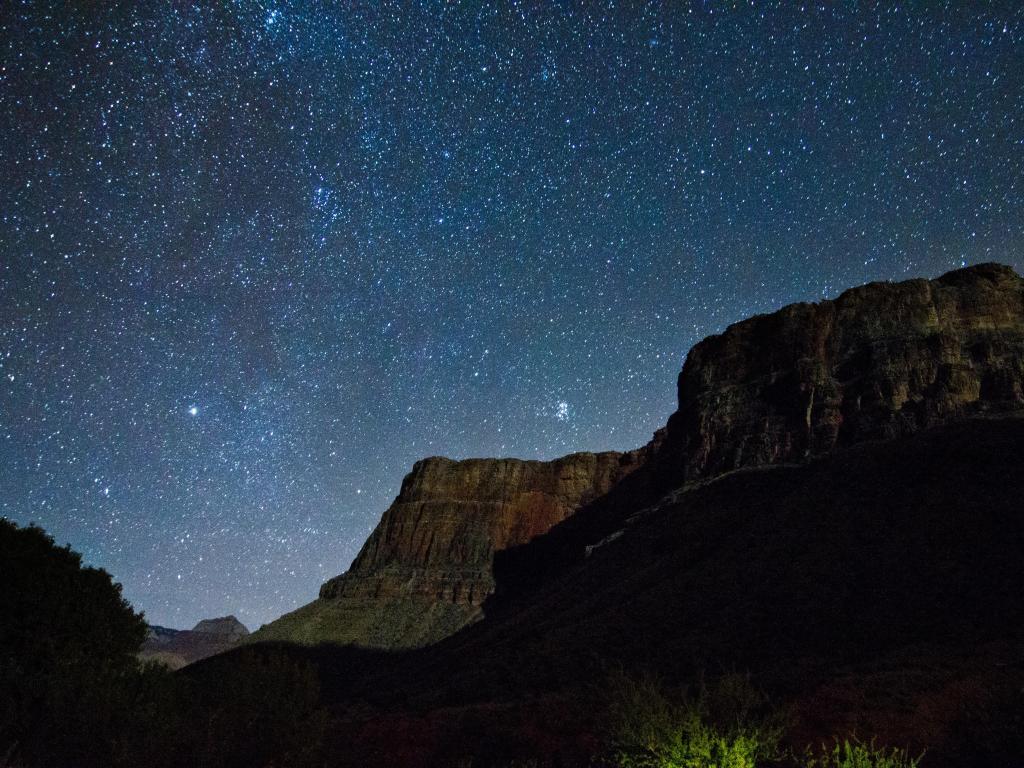 Grand Canyon starry sky, with stars clearly visible above the rugged rocks at night