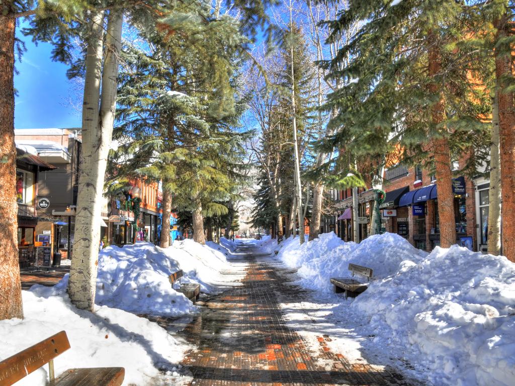 Shops and restaurants along a snowy street in central Aspen on a clear February day