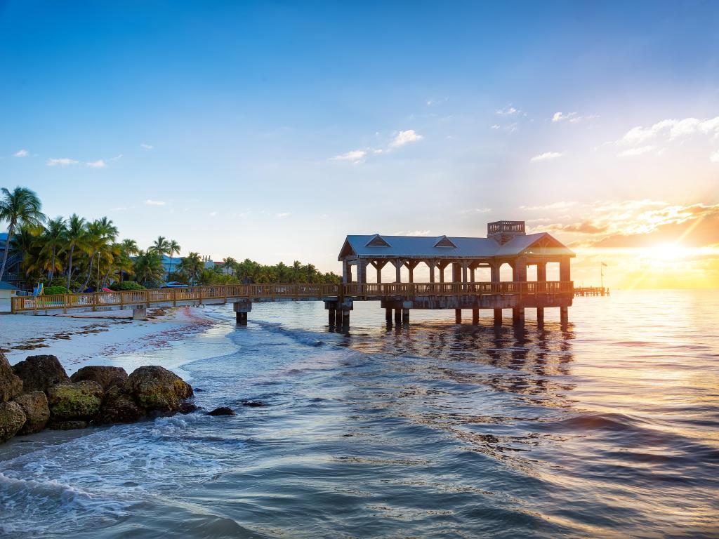 Key West, Florida, USA with a pier at the beach on sunrise.