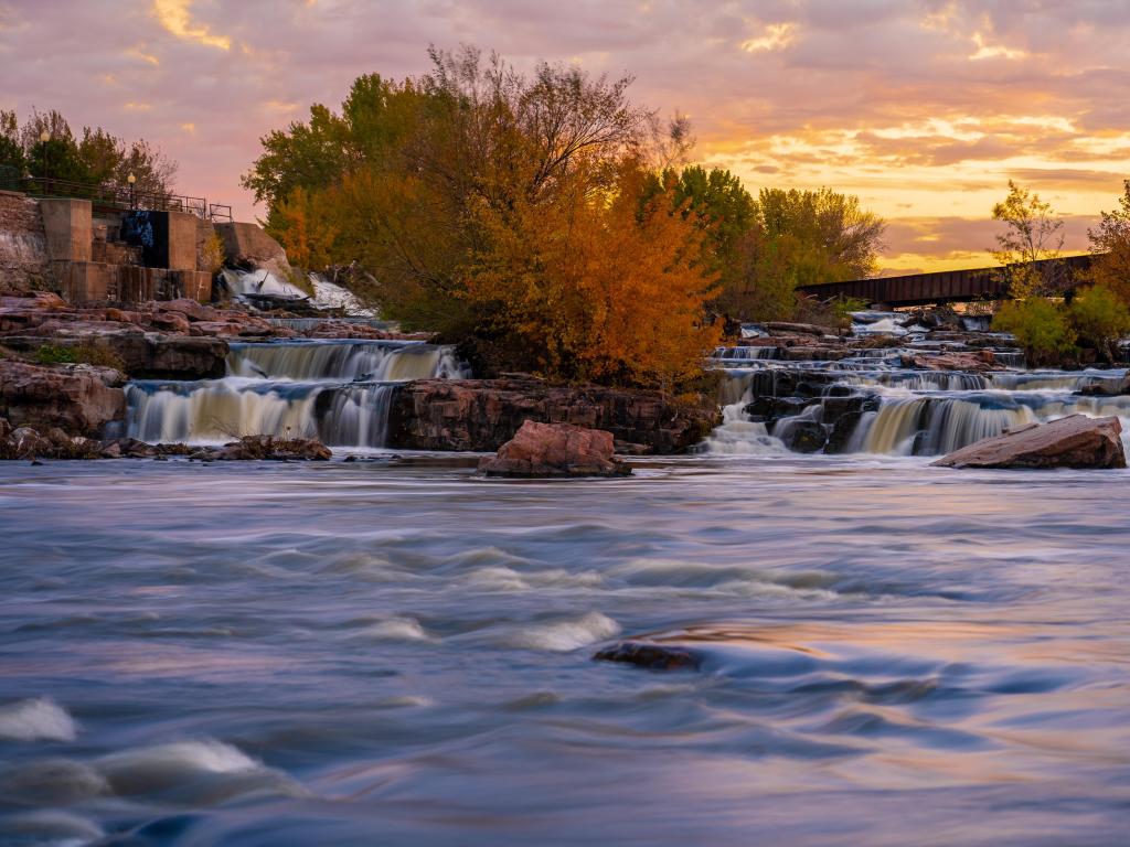 Sioux Falls flowing behind an orange sunset.