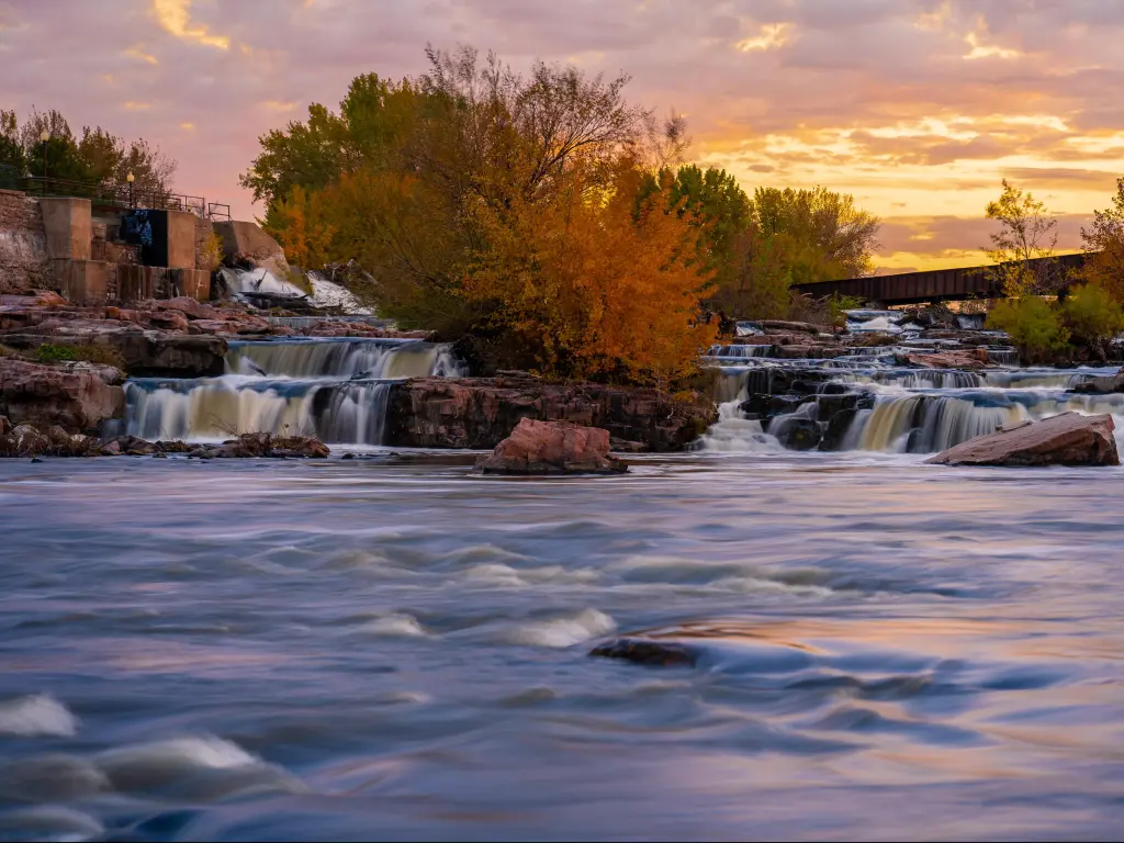 Sioux Falls flowing behind an orange sunset.