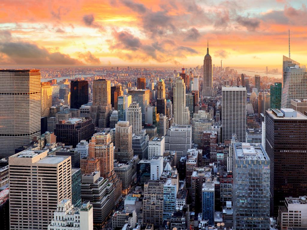 New York, USA at sunset with the skyscrapers in the foreground and the sky in red, yellows and orange. 