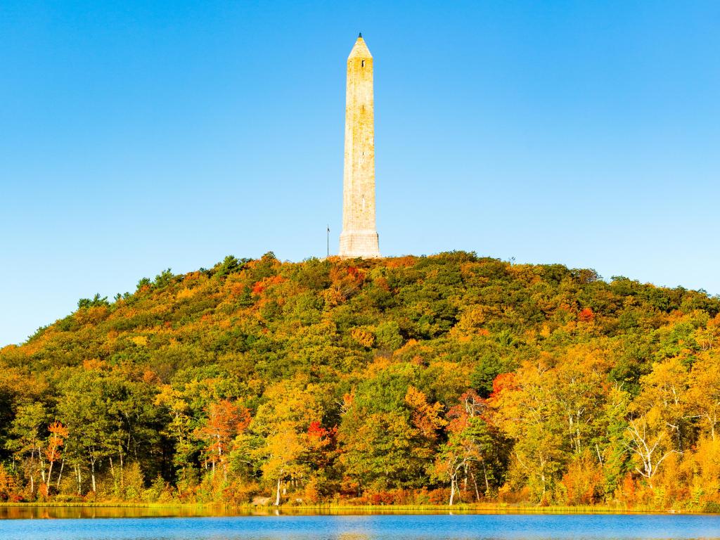 View across Lake Marcia, with High Point war veterans monument in Kittatinny mountains in the background, New Jersey